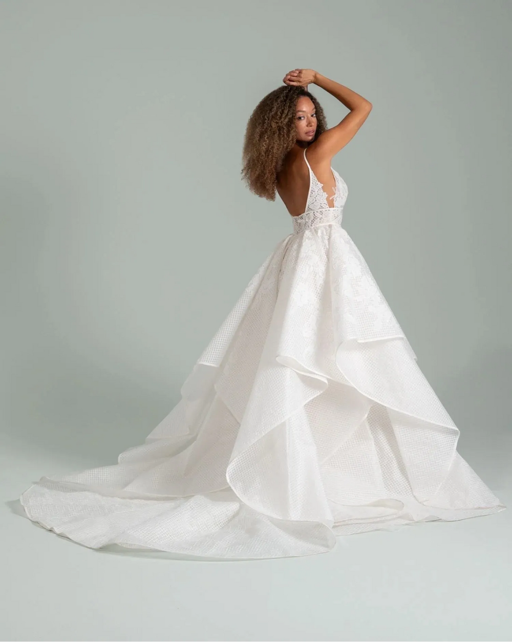 Woman wearing a white wedding dress against a gray background