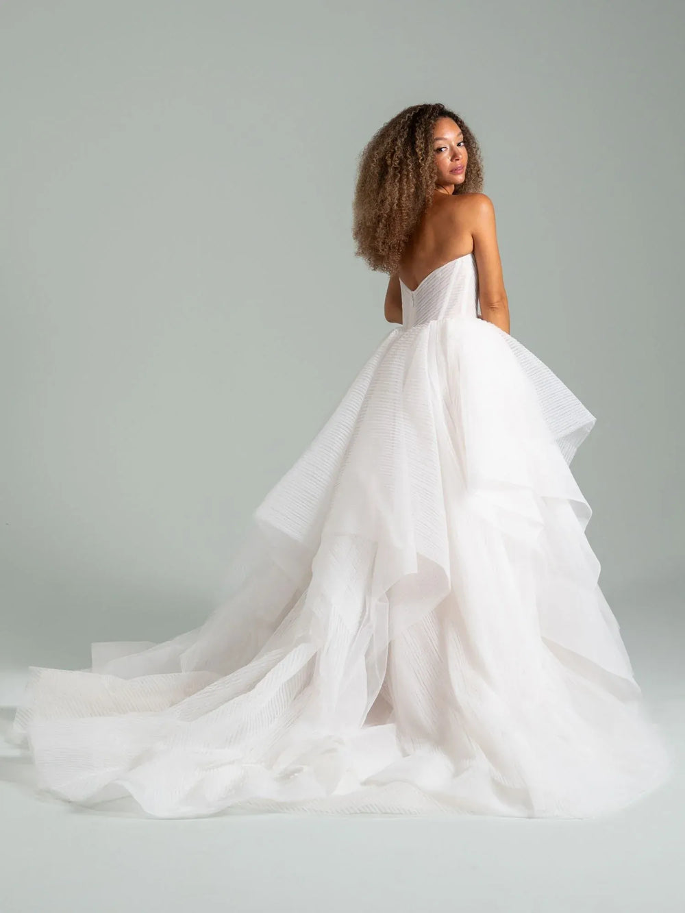 full back of hayley paige once i was a swan ivory tulle ball gown wedding dress with tiered skirt and a long train