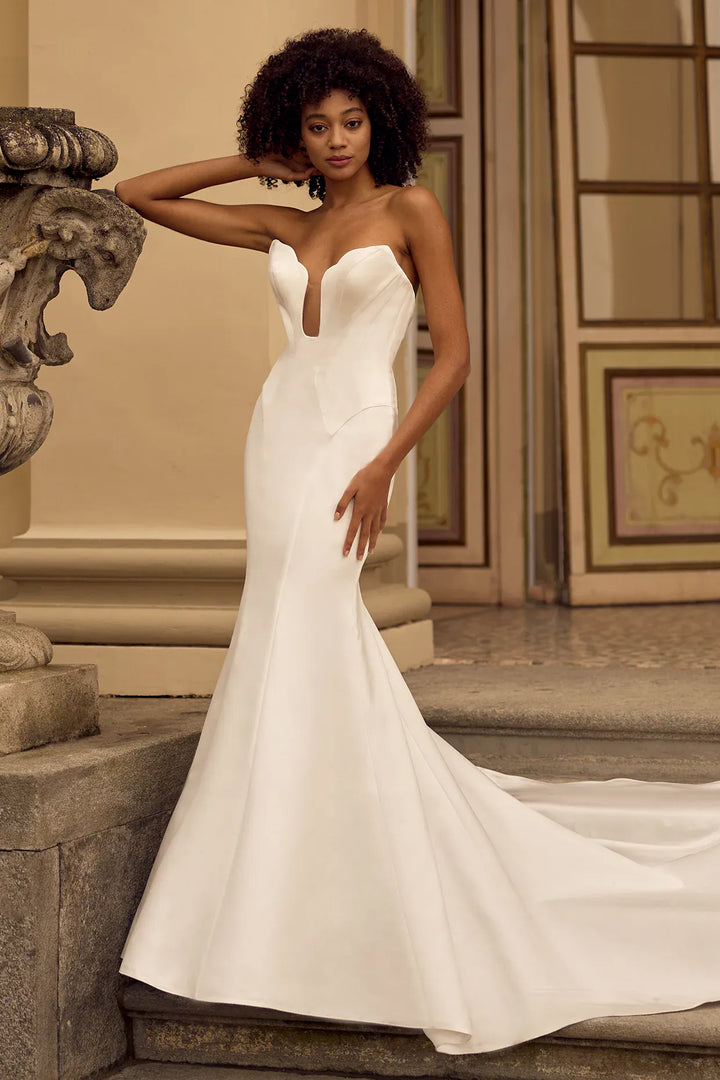 front of ines di santo quirk ivory satin fit and flare wedding dress showing the full front, with the deep plunge neckline