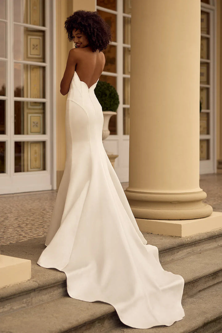 back of ines di santo quirk ivory satin fit and flare wedding dress showing the full back, with the scalloped back and shaped train