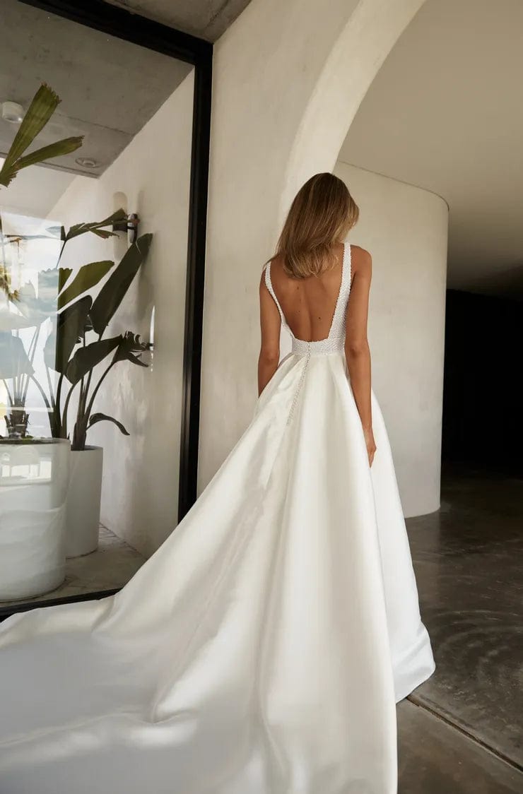 jane hill beaded wedding dress Modern, sleek, and exquisitely detailed This new Jane Hill arrival is a beaded gown featuring a high rounded neckline and a seamless, panelled bodice that flows effortlessly into a full, sculptural