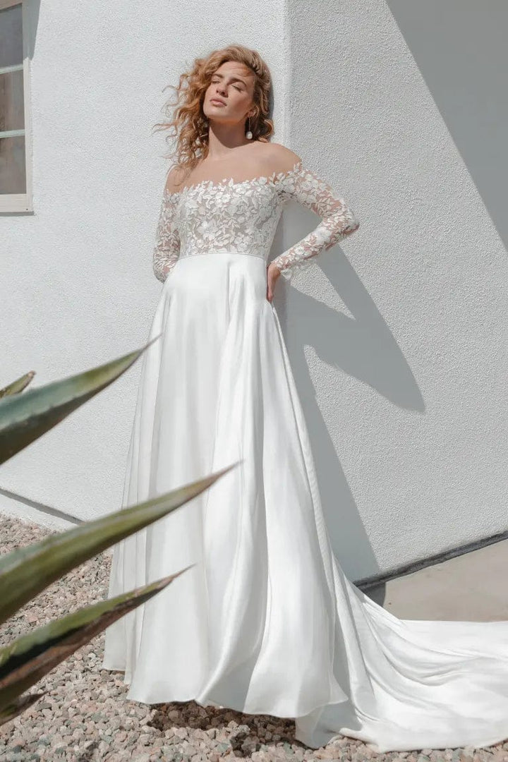 front of jenny yoo bradley ivory mikado a-line wedding dress, showing the off the shoulder lace bodice with long sleeves, and flowy skirt