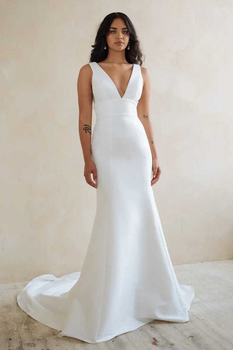 full front of jenny yoo ilana ivory crepe fit and flare wedding dress with a v neckline and thick straps