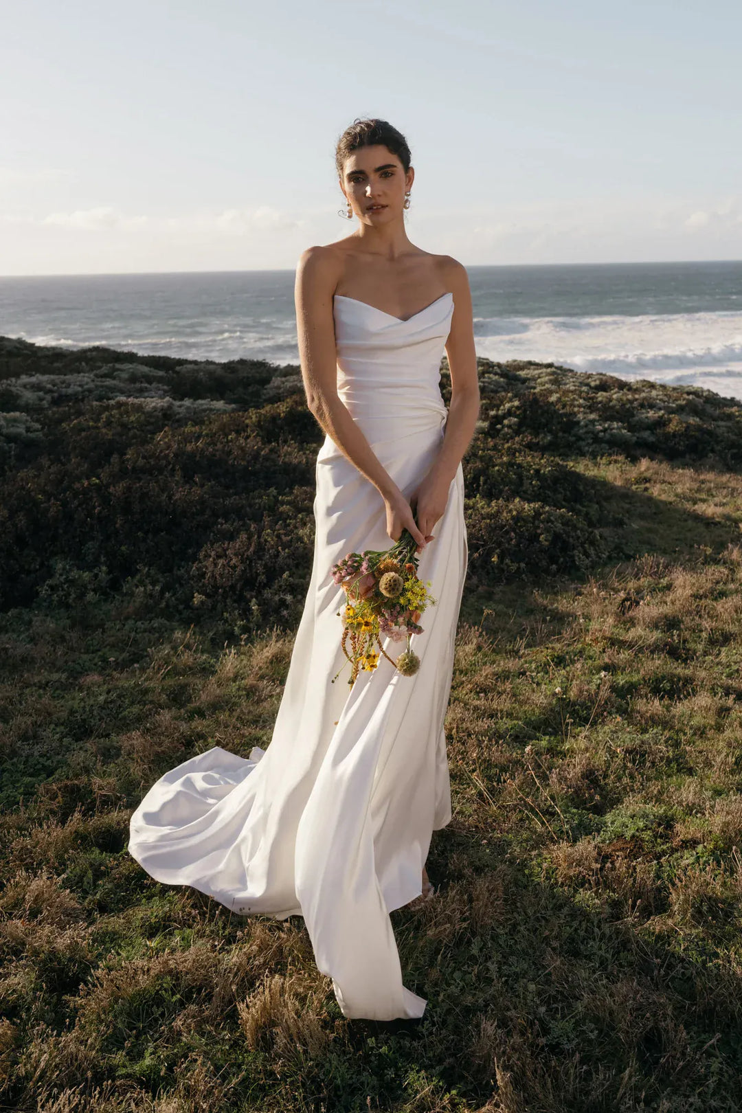 full front of jenny yoo lana satin sheath wedding dress with a strapless bodice and high slit in the skirt