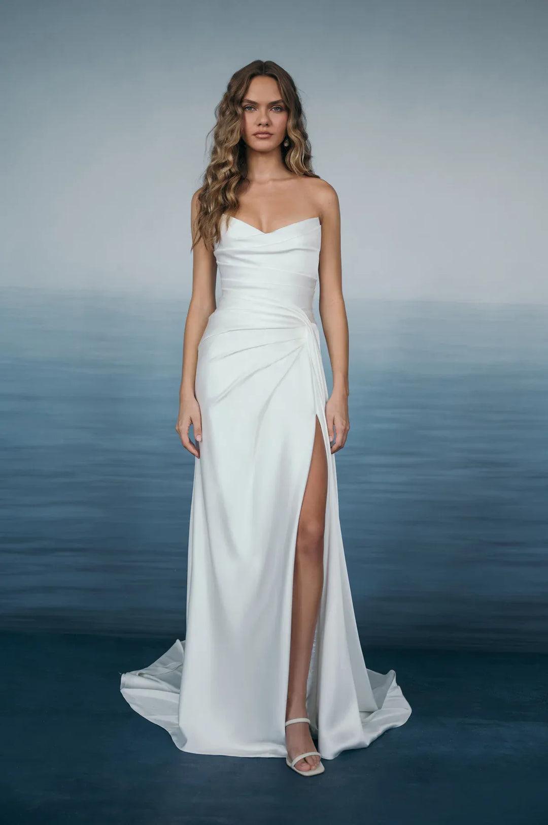 full front of jenny yoo lana satin sheath wedding dress with a strapless bodice and high slit in the skirt