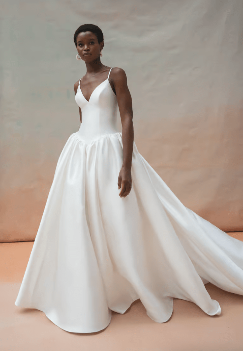 Woman wearing a white wedding dress with a plain background