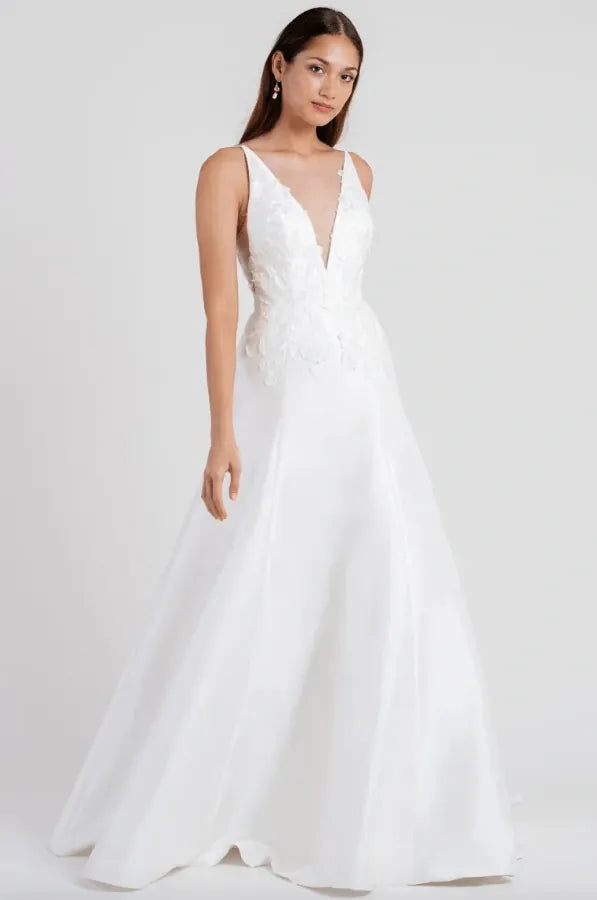 White wedding dress on a model against a white background