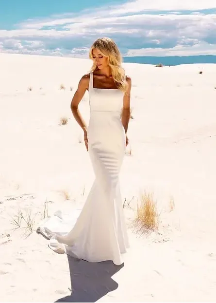 full front of jimme huang ivory crepe fitted wedding dress with a square neckline and waist belt