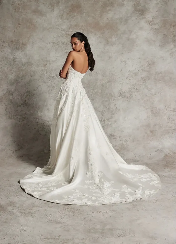 full back of justin alexander 99291 ivory satin a-line wedding dress with dimensional floral accents on the bodice that float onto the skirt