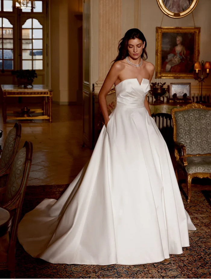 front of justin alexander jones ivory mikado a-line wedding dress with notched v neckline + pockets in the skirt