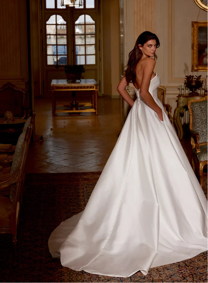 back of justin alexander jones ivory mikado a-line wedding dress with buttons down the back of the skirt onto the train