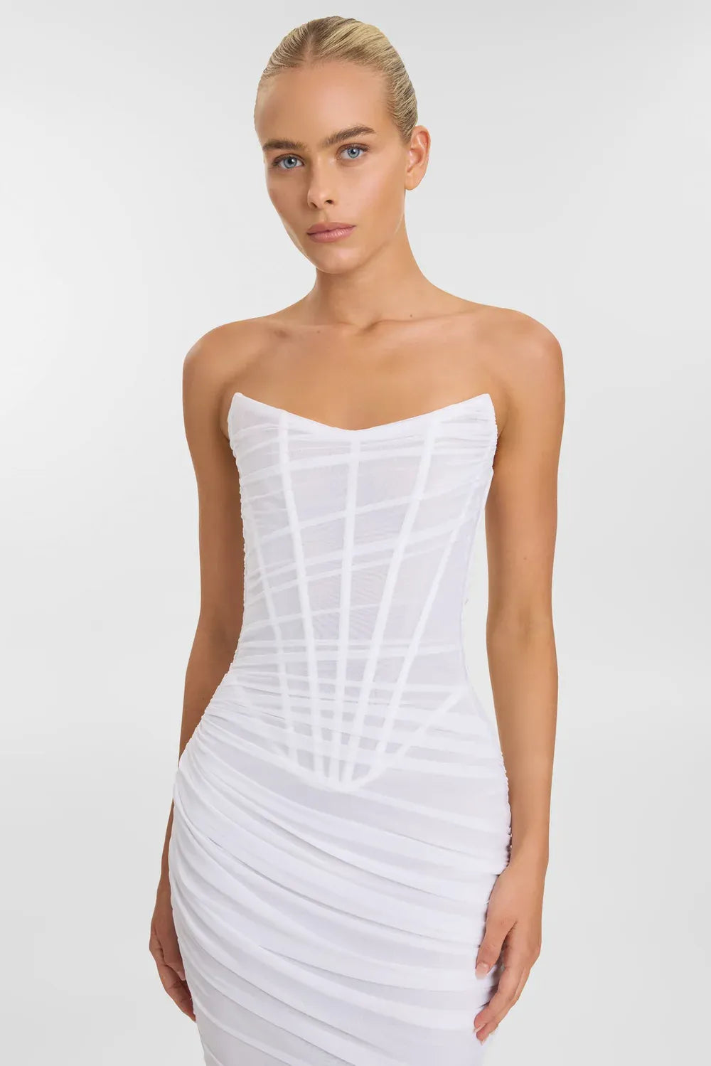 close up of kyha blanc ivory mesh fitted wedding dress with a basque waist and strapless bodice