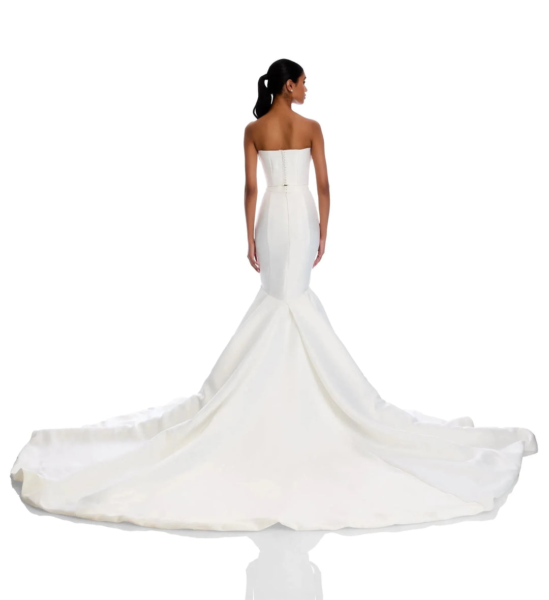 White strapless wedding dress with a long train on a white background