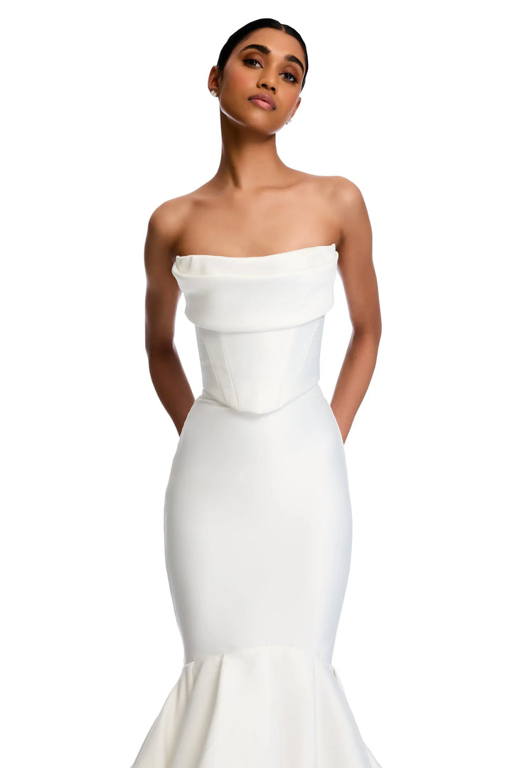 Woman wearing a white strapless gown on a white background