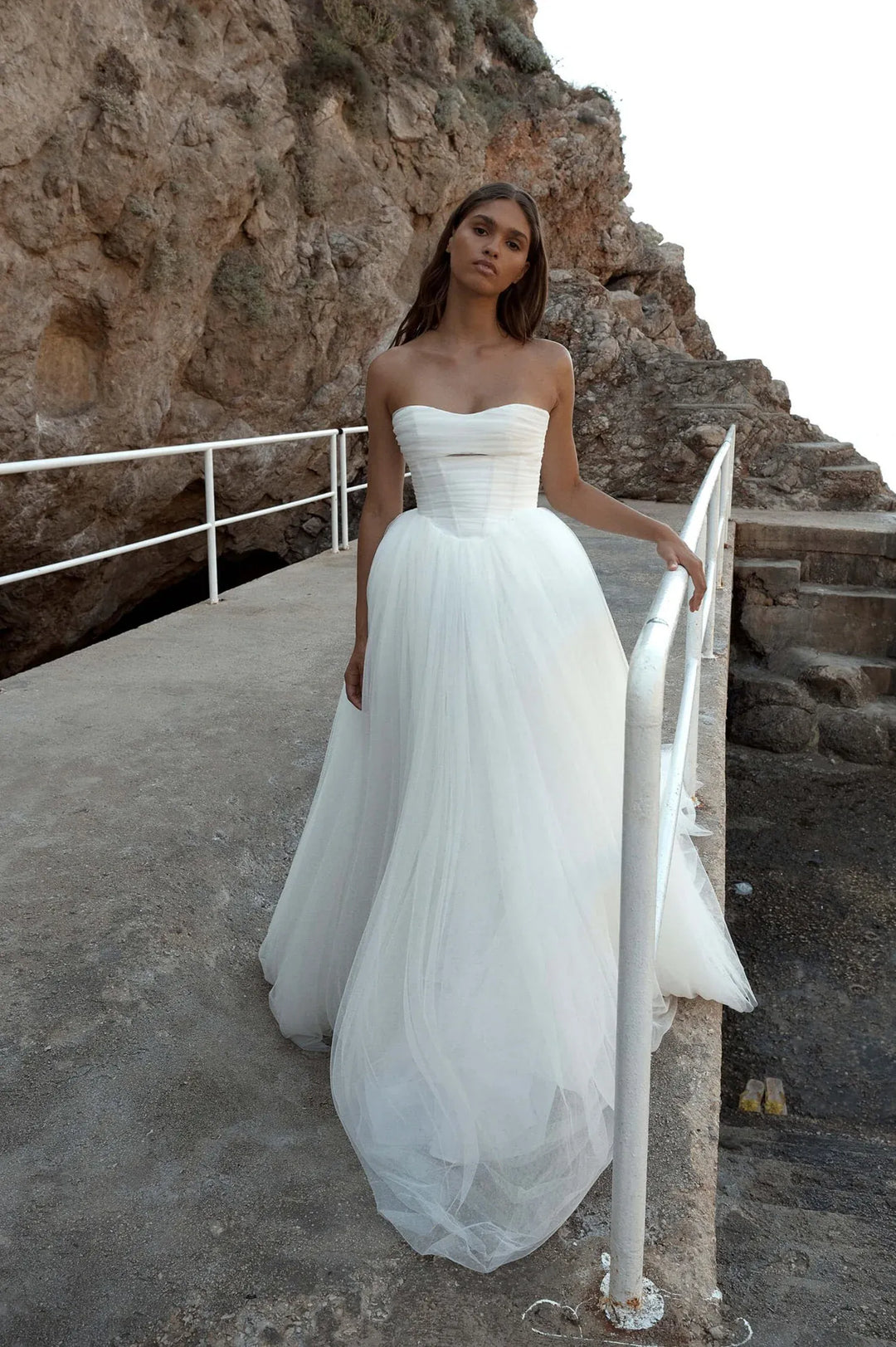 full front of kyha malibu ivory tulle ball gown wedding dress featuring a basque waist and strapless bodice