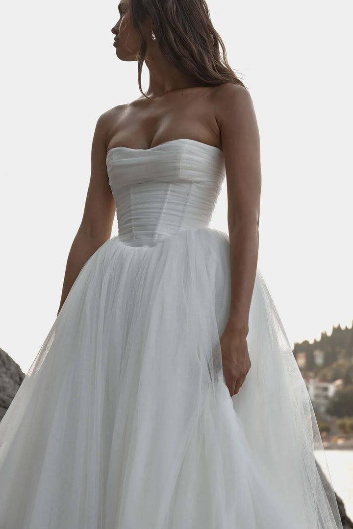 close up of kyha malibu ivory tulle ball gown wedding dress featuring a basque waist and strapless bodice