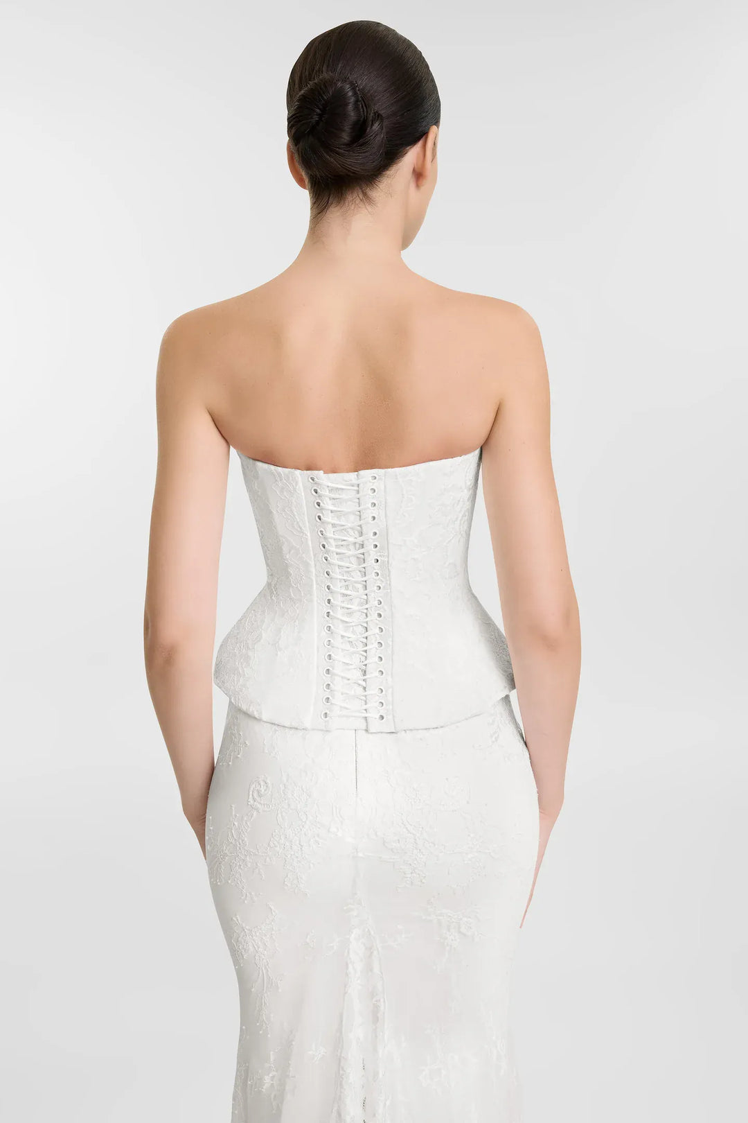 close up of the back of kyha october corset and clover skirt with ivory lace and a strapless top