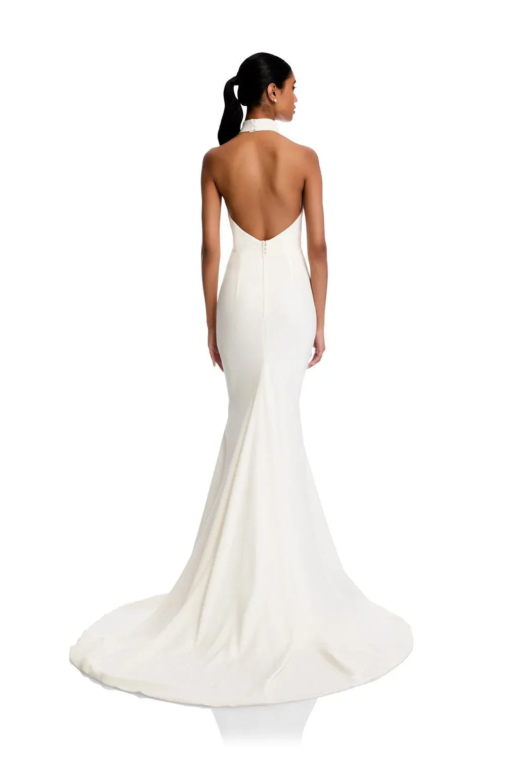Woman wearing a white evening gown with an open back on a white background