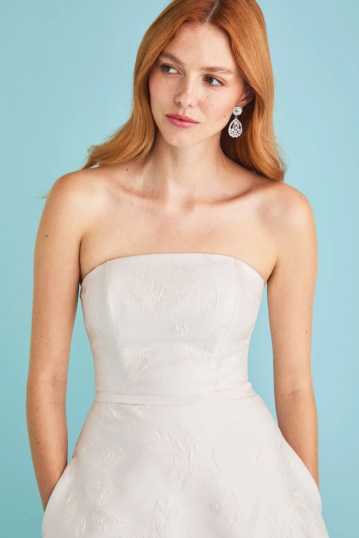 close up of lea-ann belter gwen ivory jacquard a-line wedding dress with a strapless neckline and oversized bow at the back