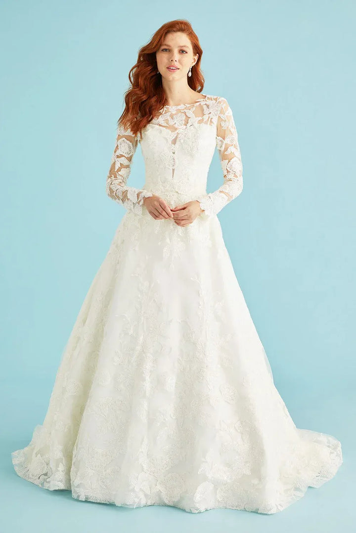 Woman wearing a white lace wedding dress against a light blue background