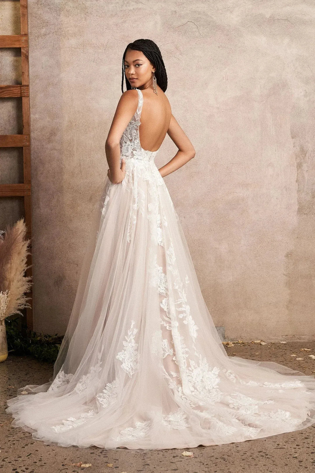 full back of lillian west 66225 nude tulle a-ine wedding dress featuring an open back, full skirt, and chapel length train
