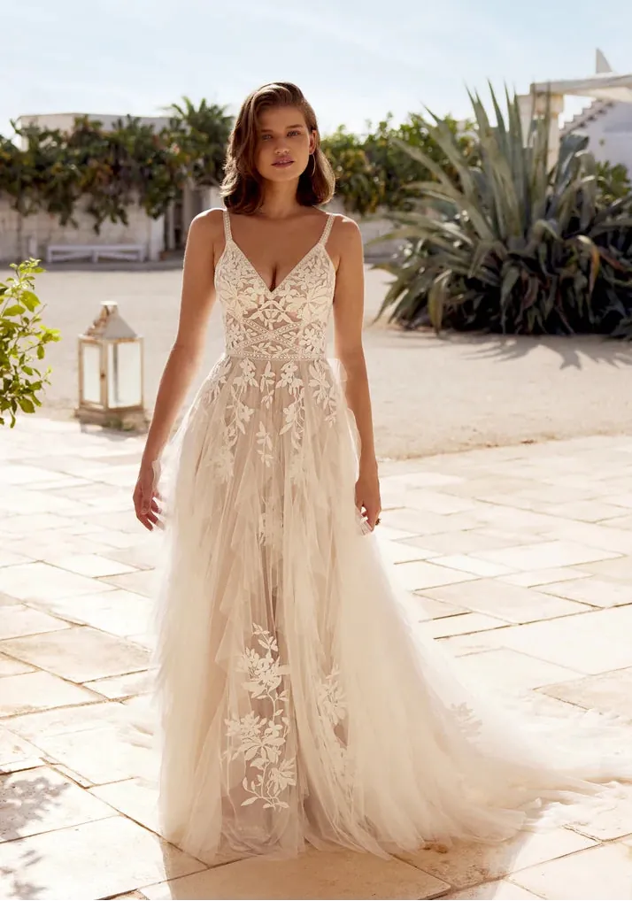 full front of lillian west 66407 champagne tulle a-line wedding dress featuring a v neckline, lace appliques, and breezy skirt