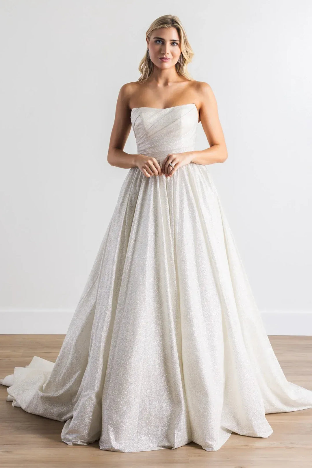 full front of watters vanity silver sparkle tulle ball gown featuring a strapless scoop neckline and full skirt