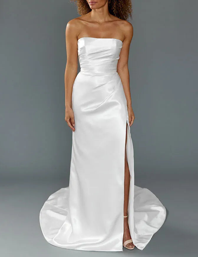 full front of louvienne cruz satin ivory fitted wedding dress with a strapless straight neckline and slit in the skirt