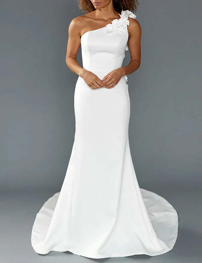 front of louvienne enzo ivory crepe fitted wedding dress with a one shoulder neckline with dimensional floral accents