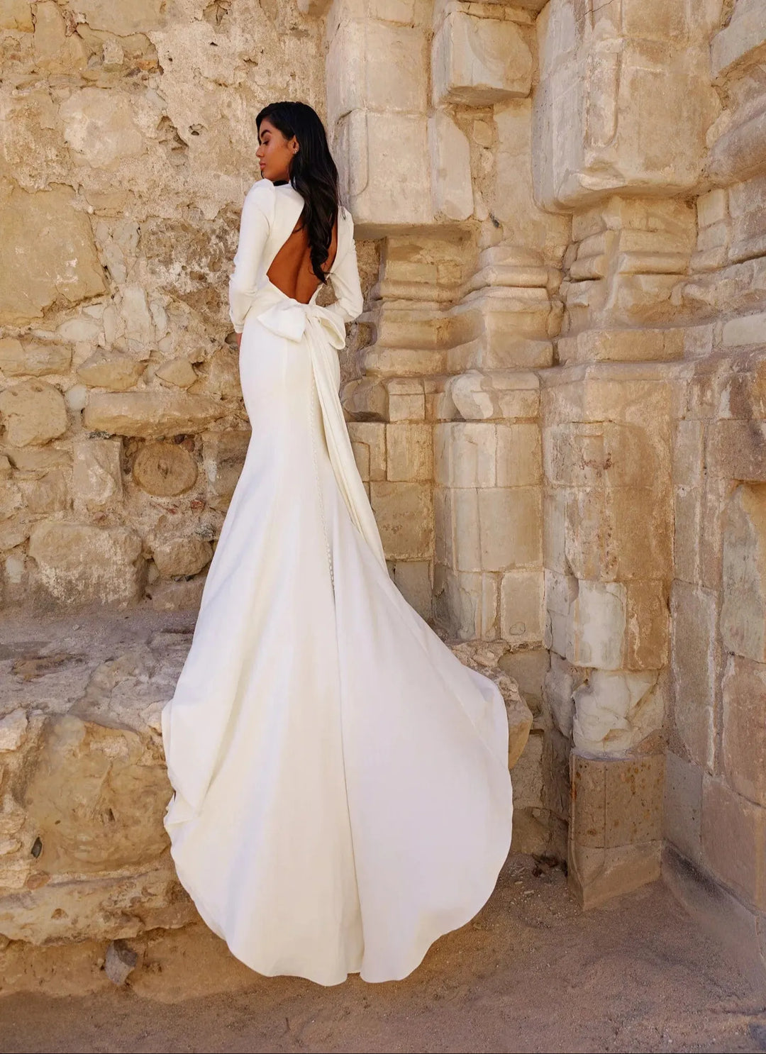 full back of louvienne jett ivory crepe wedding dress showing the matching jett bow