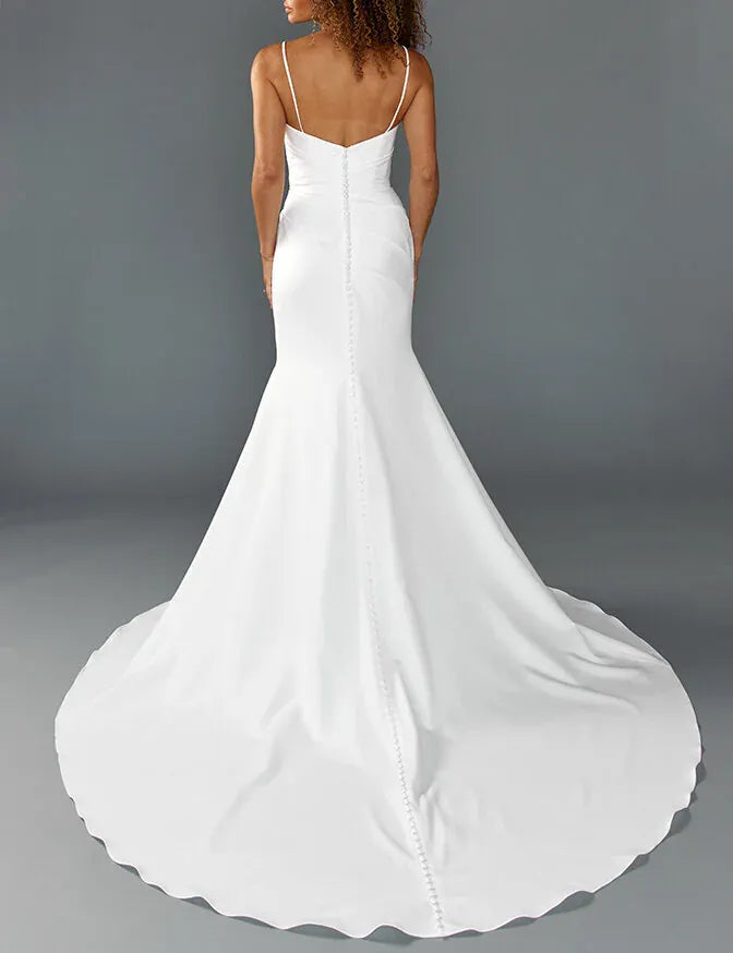back of louvienne rocky crepe ivory fitted wedding dress with a ruched bodice and chapel length train