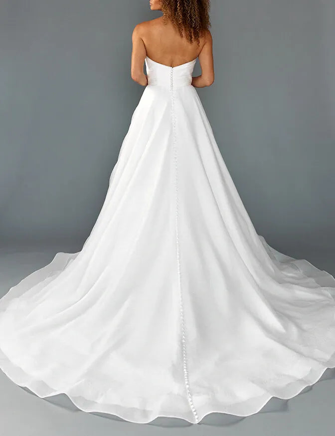 back of louvienne sutton ivory organdy a-line wedding dress with buttons down the back of the chapel length train