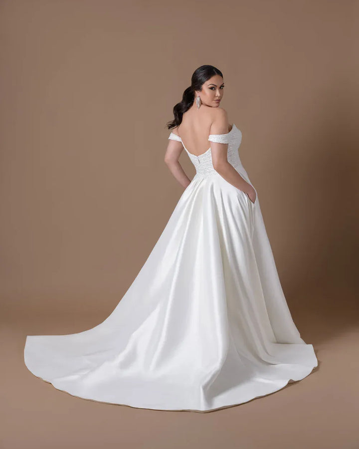 back of dany girl luxe ivory satin ball gown wedding dress with a beaded bodice and simple train