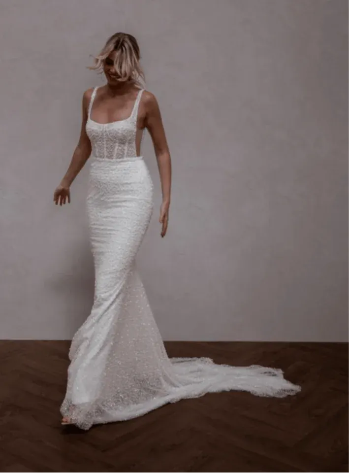 front of made with love freddie ivory beaded fit and flare wedding dress with a square neckline and fitted skirt