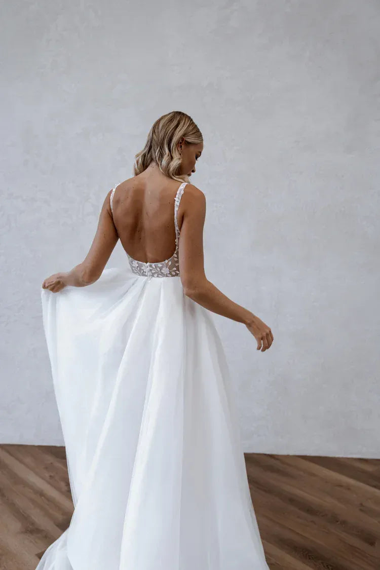 back of made with love huxley ivory tulle a-line wedding dress with an open back and flowy skirt