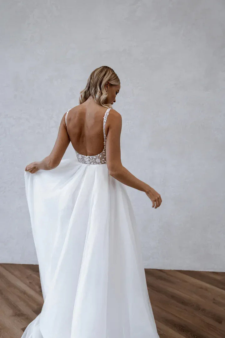 back of made with love huxley ivory tulle a-line wedding dress with an open back and flowy skirt