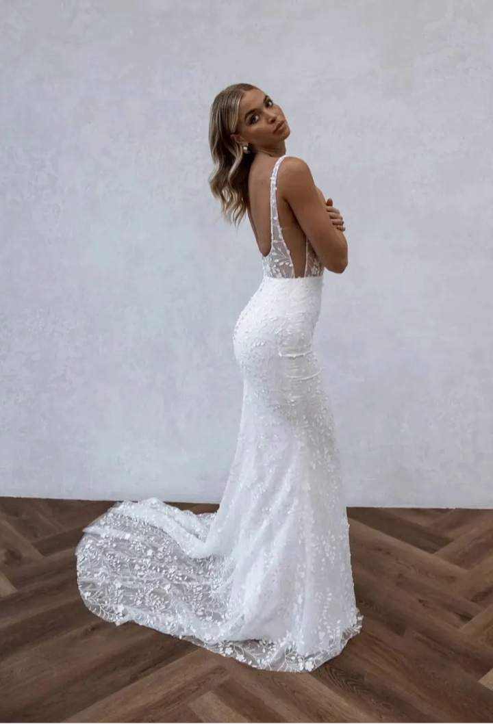 back of made with love huxley ivory lace fitted wedding dress with deep cut sides and a sheer train
