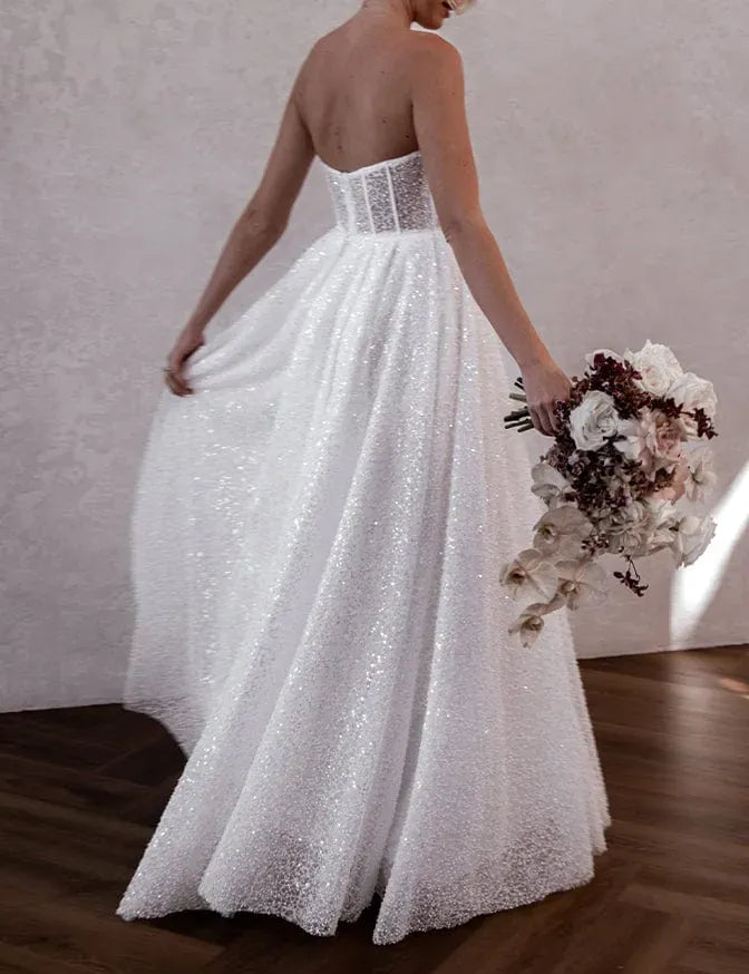 full back of made with love sebastian ivory beaded a-line wedding dress with a square neckline and thin straps, with a floor length skirt