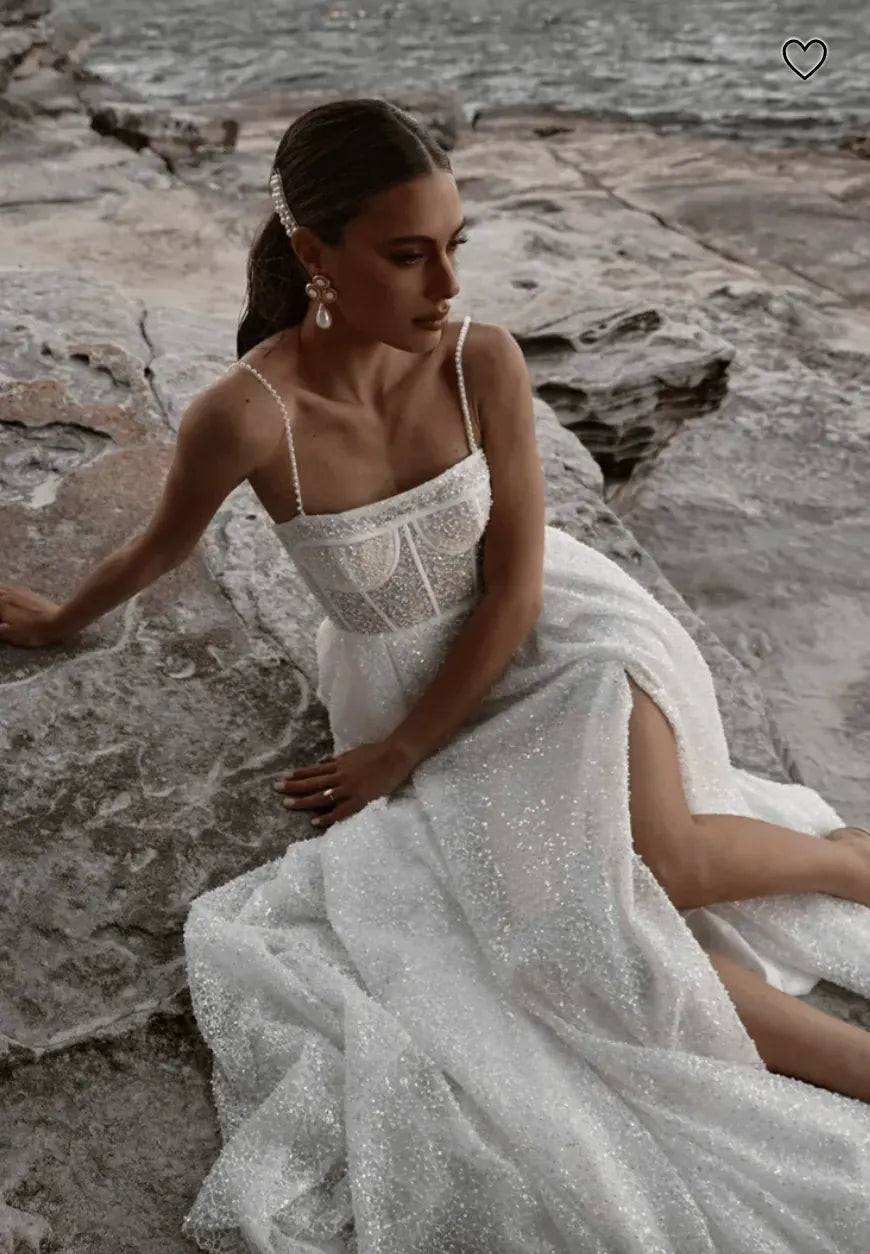 close up of made with love sebastian ivory beaded a-line wedding dress with a square neckline and thin straps