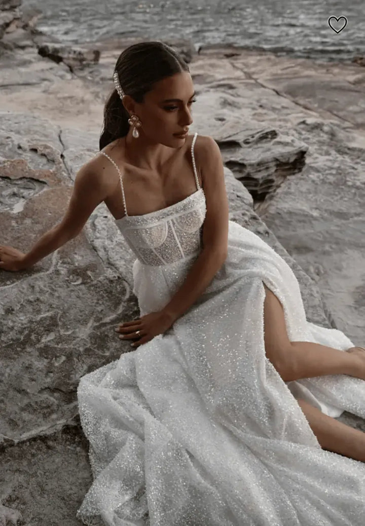 close up of made with love sebastian ivory beaded a-line wedding dress with a square neckline and thin straps