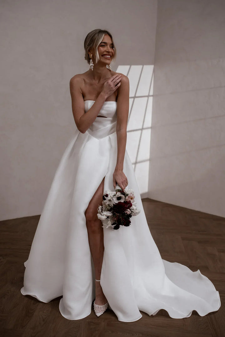 full front of made with love sloane ivory organza a-line wedding dress with a strapless bodice and keyhole cutout on the front