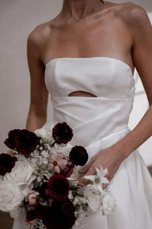 close up of made with love sloane ivory organza a-line wedding dress with a strapless bodice and keyhole cutout on the front