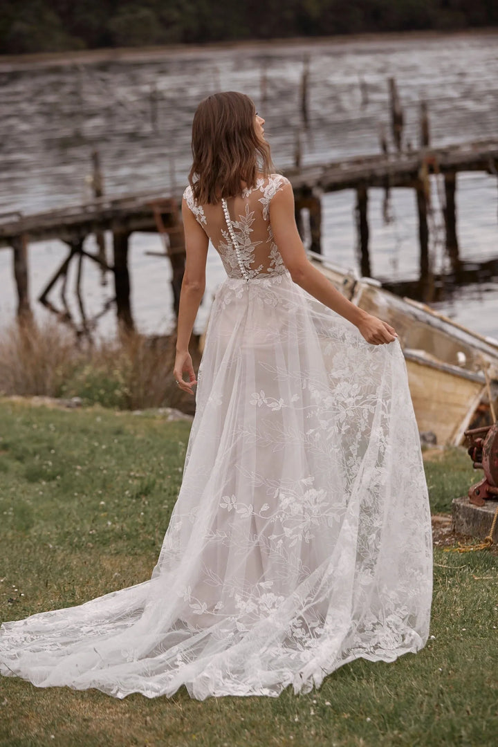 full back of madi lane camille ivory lace a-line wedding dress with a sheer back and chapel length train