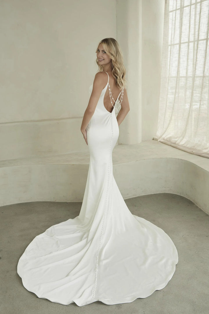 full back of madi lane eyre ivory satin wedding dress with an open back and beaded accents