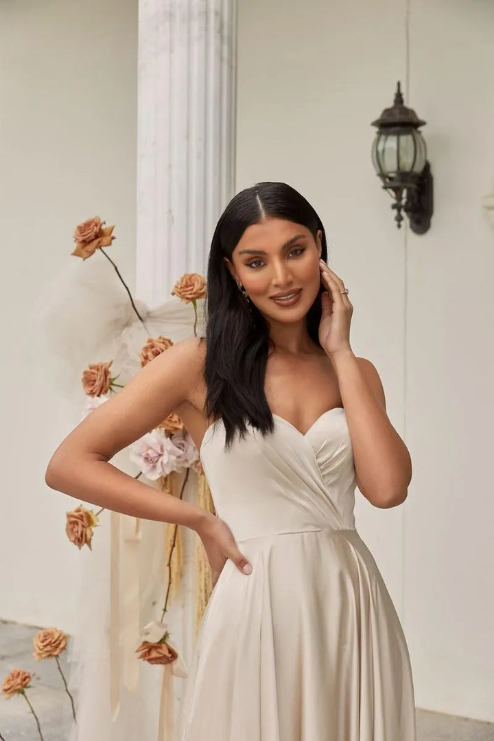 close up of madi lane ml22046 ivory satin a-line wedding dress, shown without the detachable long sleeves