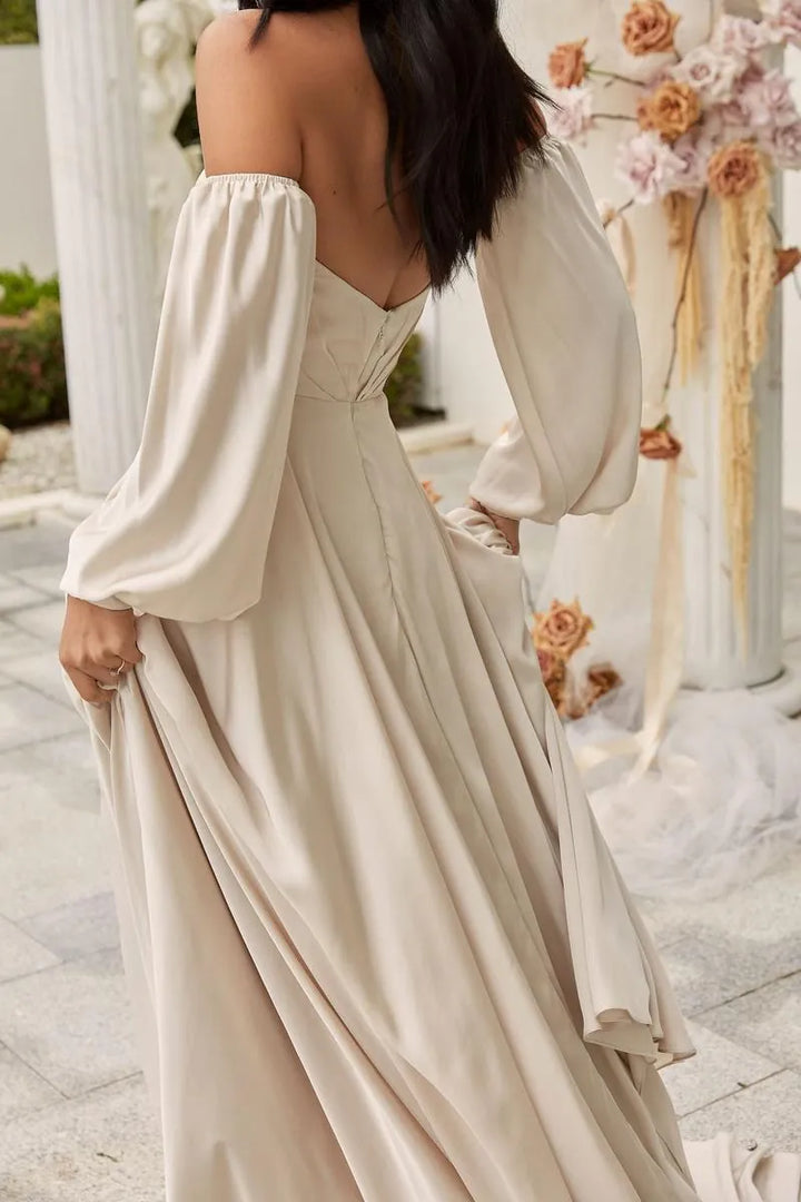 close up of madi lane ml22046 ivory satin a-line wedding dress showing the back, with detachable long sleeves