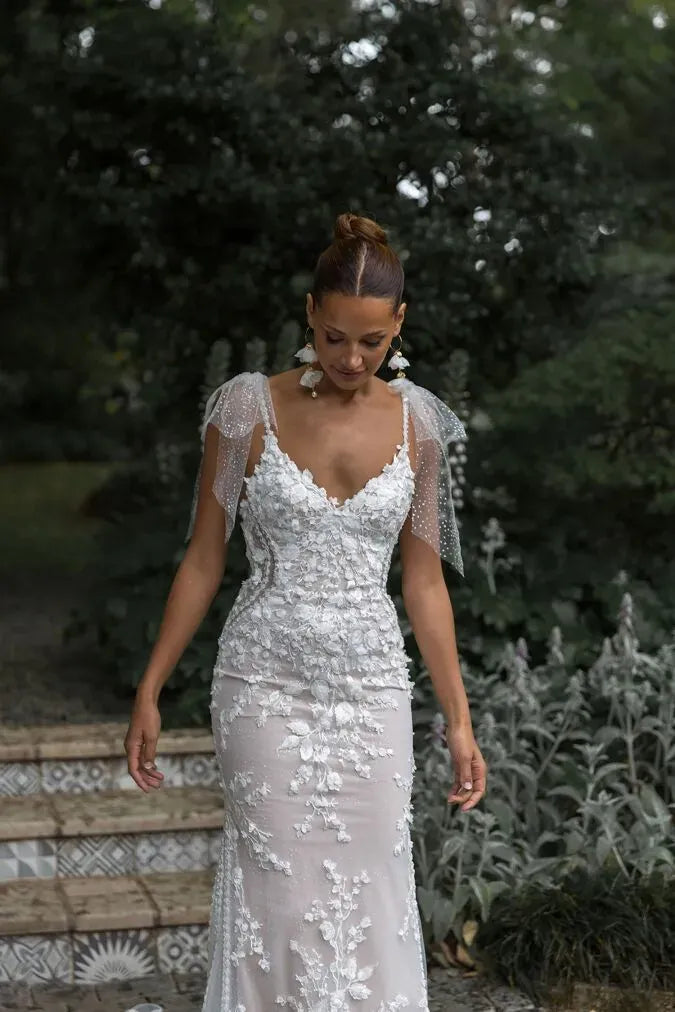 close up of madi lane ml23575 nude tulle fitted wedding dress with lace accents and shimmer tulle bows at the shoulders