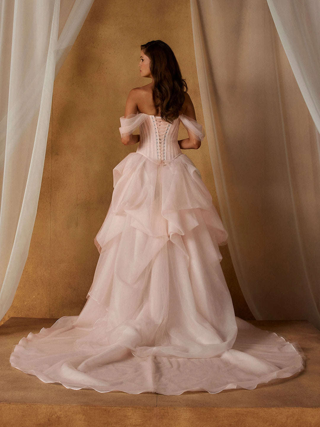 back of madi lane nickel and novella set. the nickel bodice has a lace up back, and the novella skirt has a short circle train
