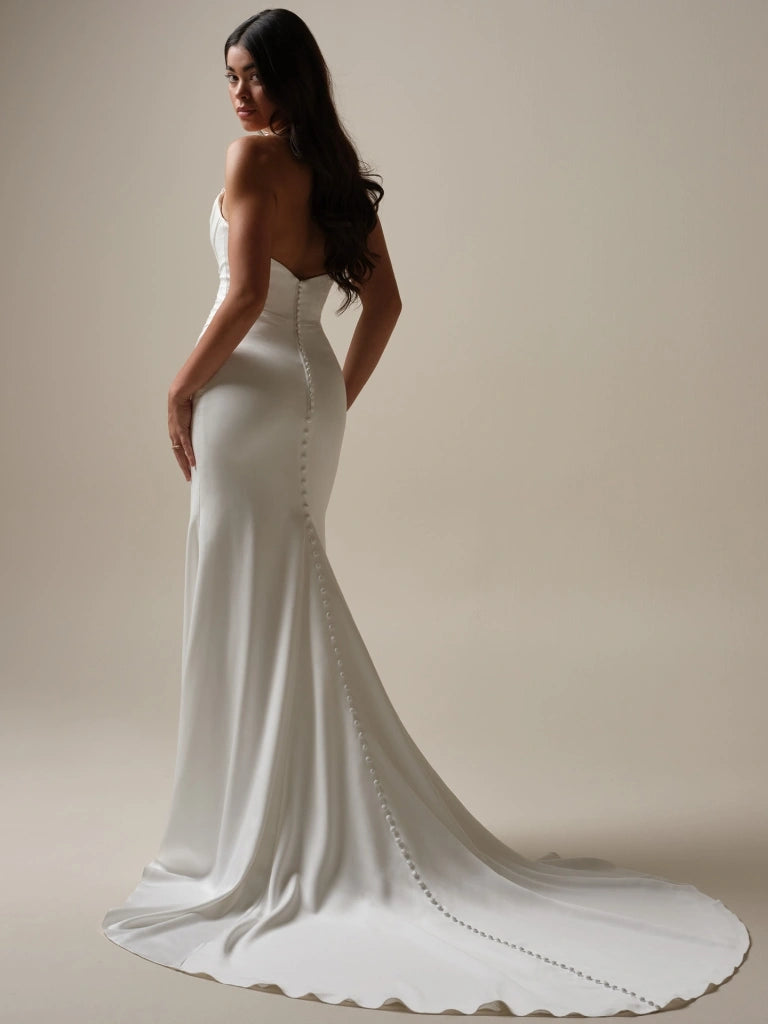 full back of maggie sottero camille ivory satin fitted wedding dress featuring a strapless bodice and chapel length train, showing without the matching overskirt