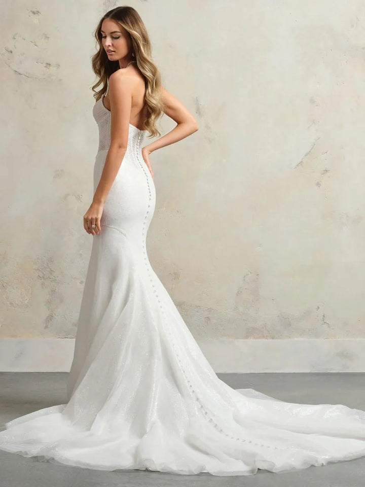 full back of maggie sottero esme ivory tulle fit and flare wedding dress with buttons down the back and a chapel length train